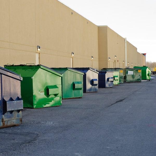 multiple commercial dumpsters for industrial waste management